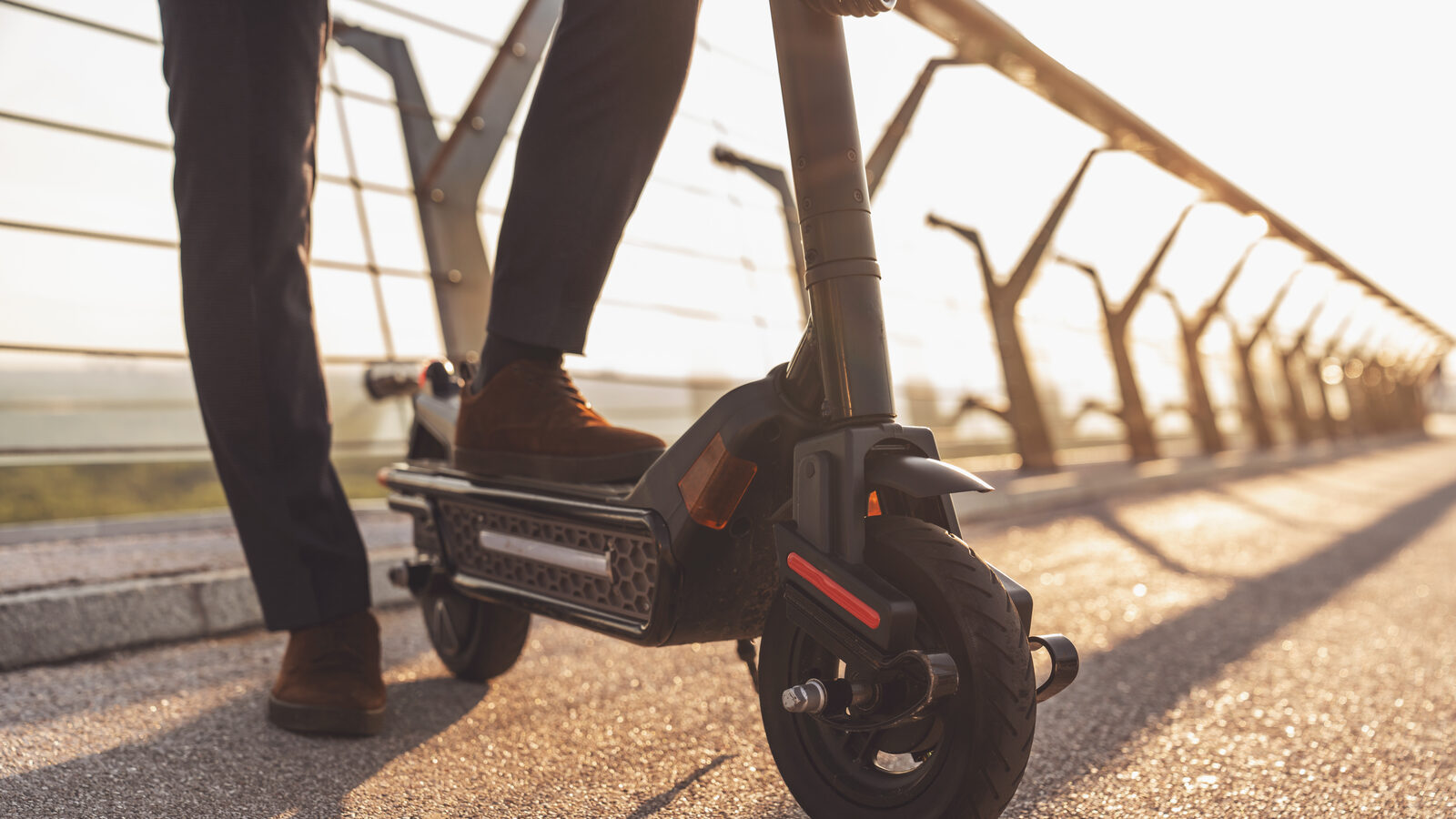 Close-up of an electric scooter's deck, backlit