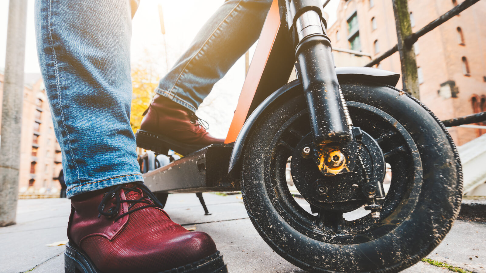 Close-up of an electric scooter's front wheel and controls