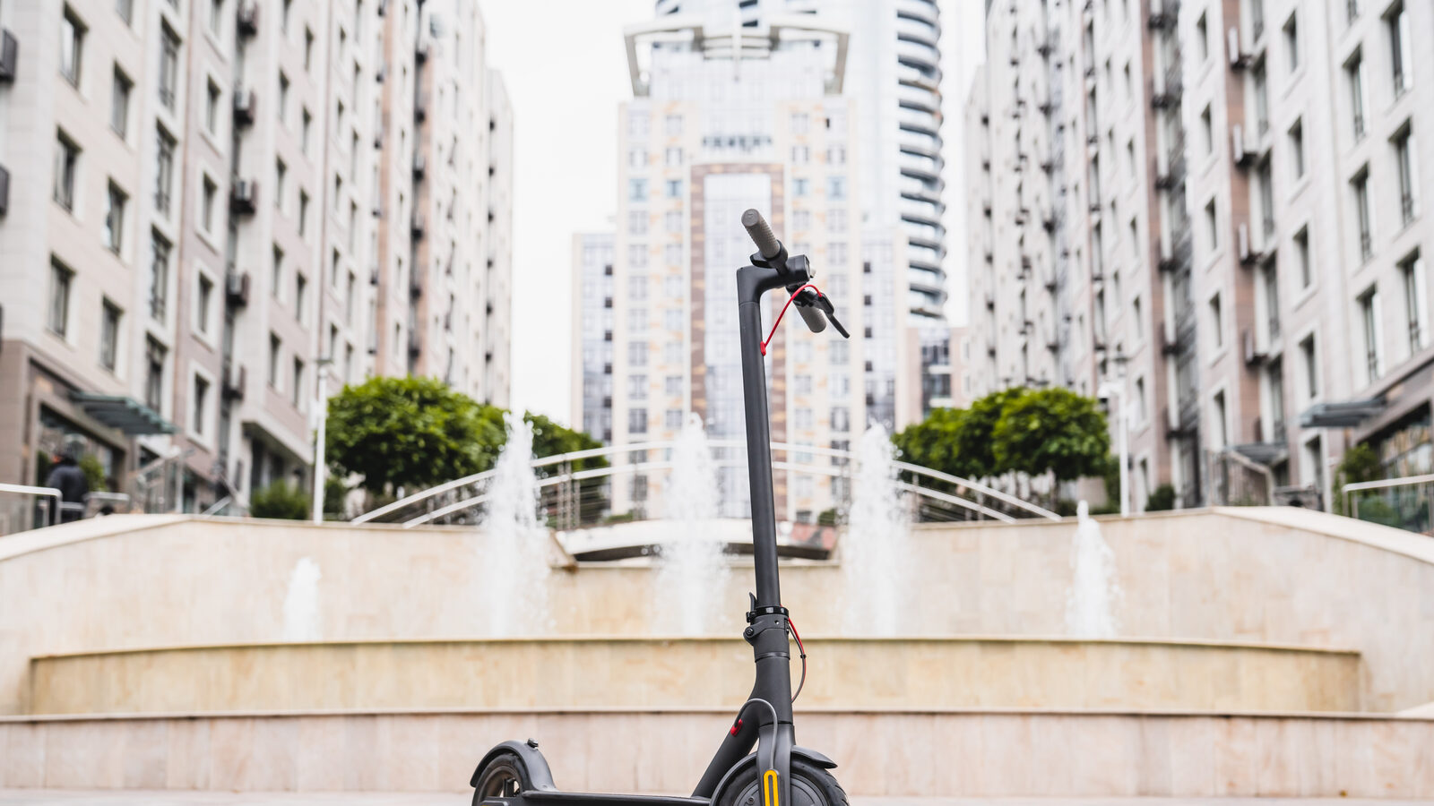 An electric scooter parked in an urban plaza